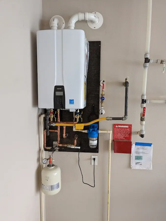 Professional plumber installing copper piping in a Greenwood home